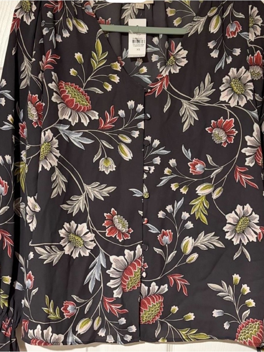 LOFT grey floral blouse with white, red, and green flowers and ruffle cuffs